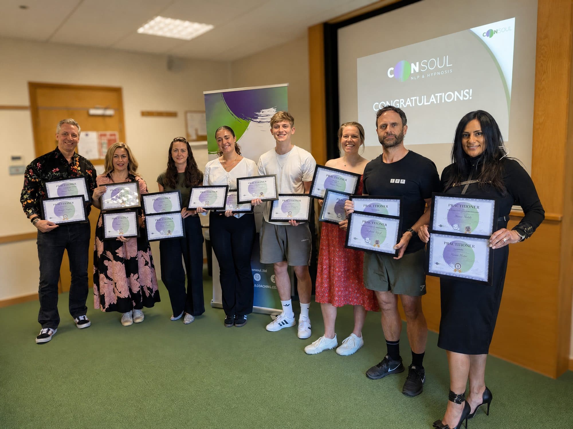 A Consoul cohort holding their Practitioner certificates